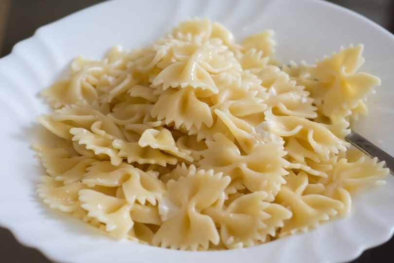 Cooked ribbon pasta on a white plate